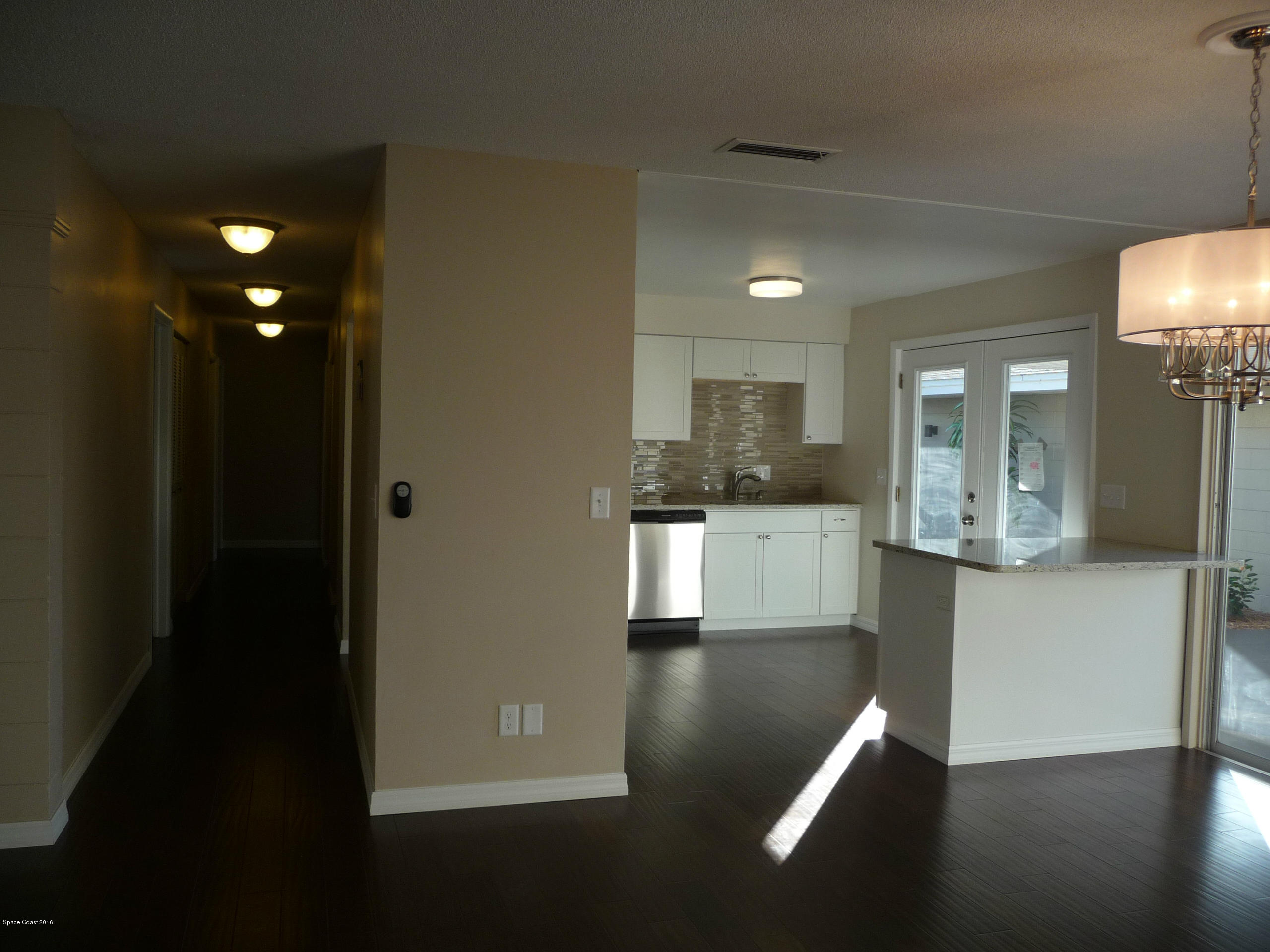 938 Brunswick Lane Rockledge, FL 32955 - Photo 14 of 57 Dining, Kitchen and hall to bedrooms