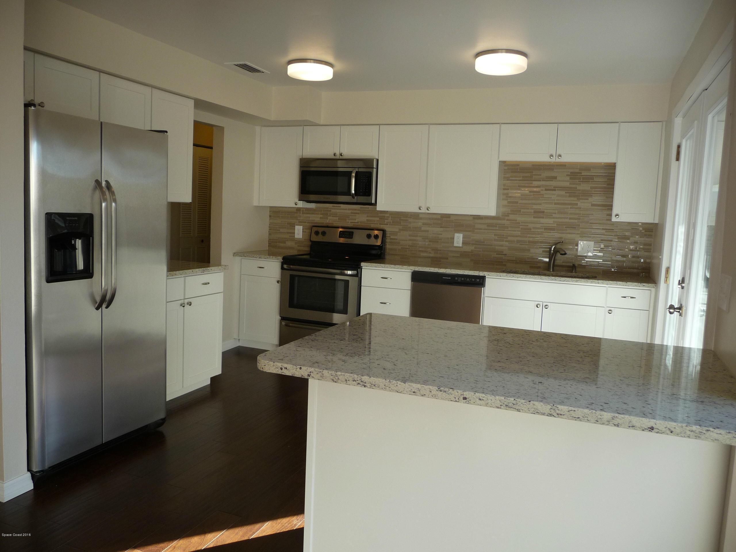 938 Brunswick Lane Rockledge, FL 32955 - Photo 20 of 57 Wide open Kitchen w/ french doors