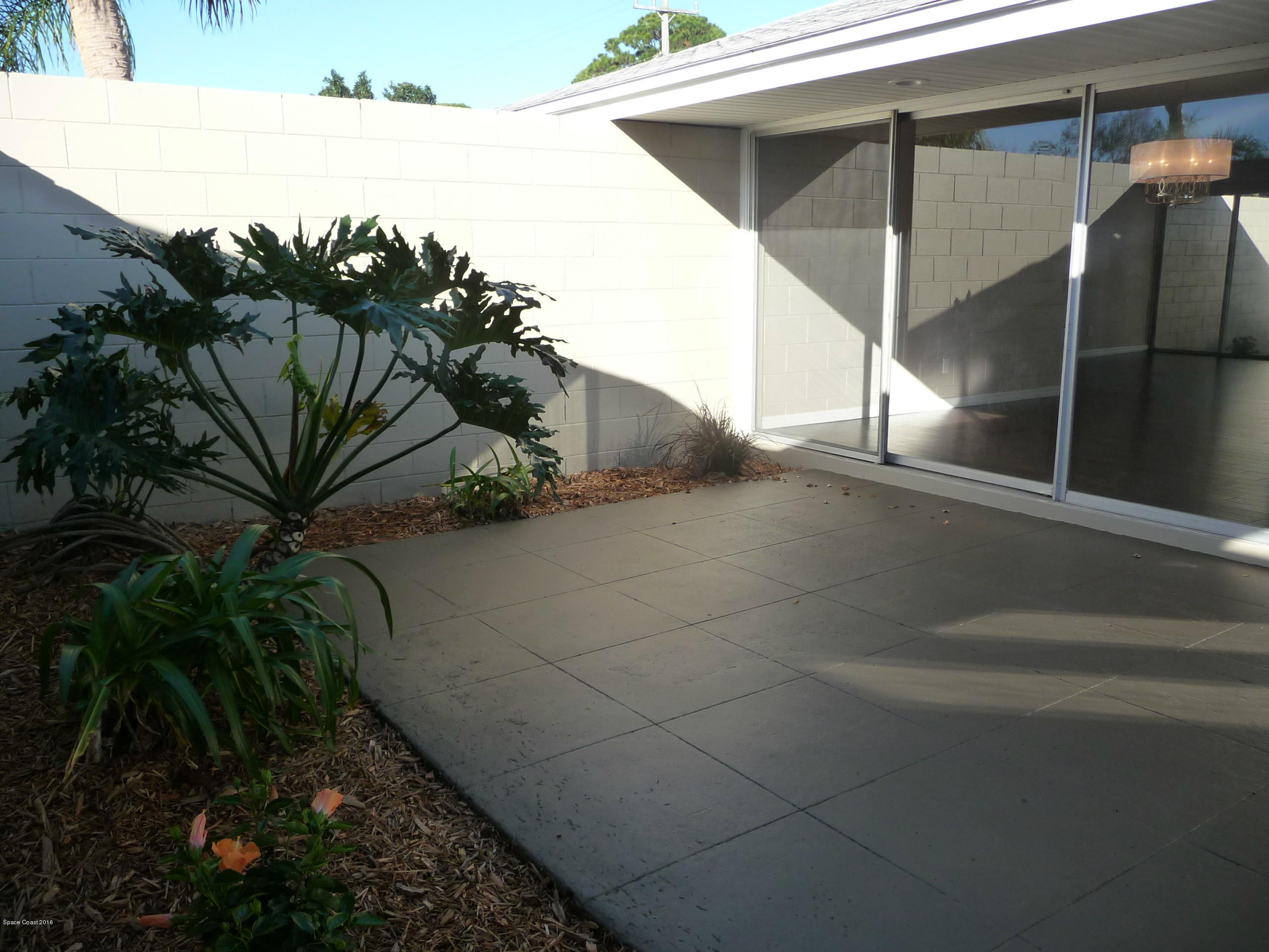 938 Brunswick Lane Rockledge, FL 32955 - Photo 42 of 57 Front Courtyard from gate to dining