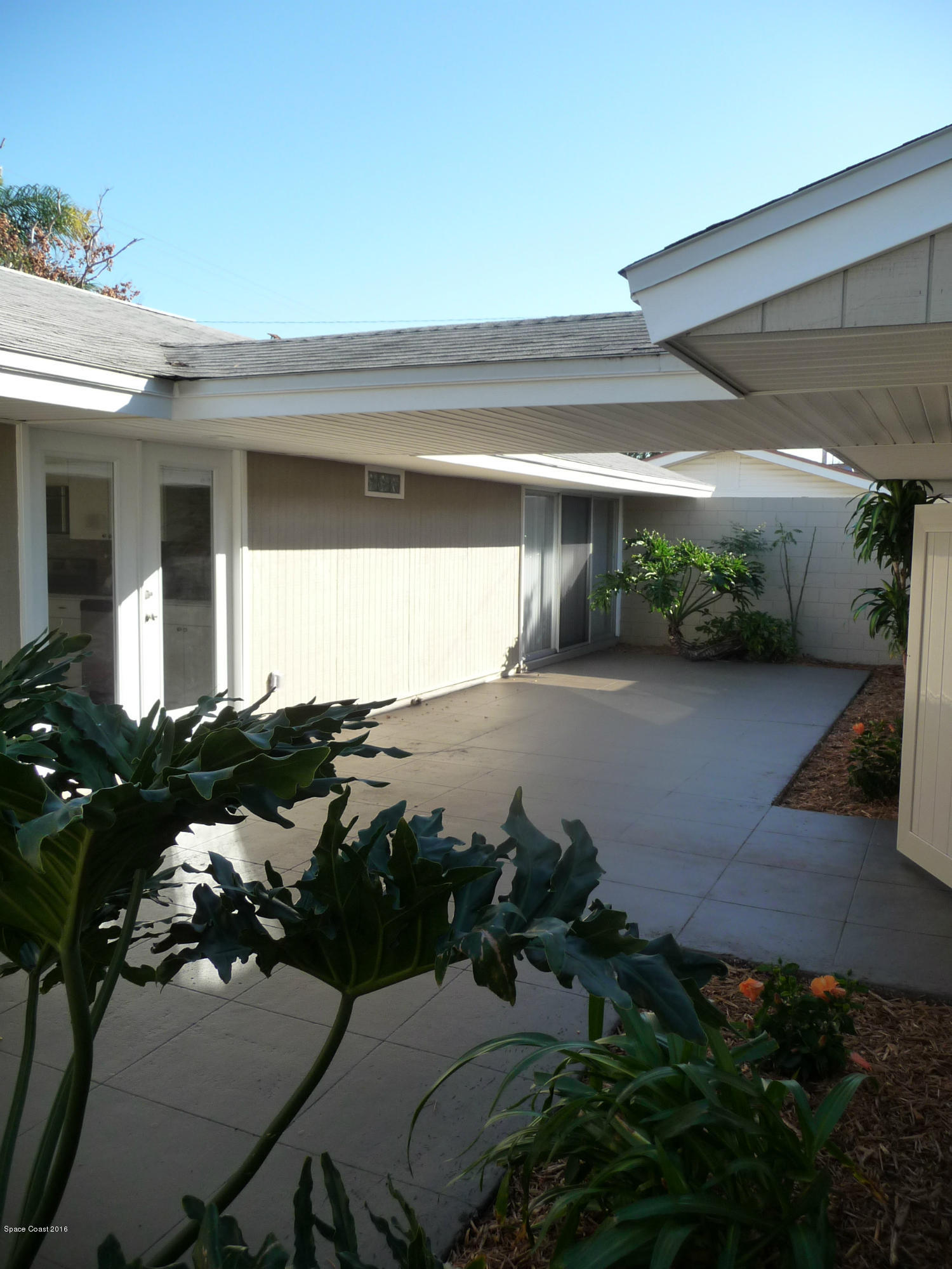 938 Brunswick Lane Rockledge, FL 32955 - Photo 48 of 57 Front Courtyard Looking @ Kitchen doors