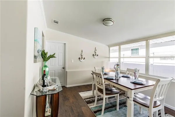 a view of a dining room with furniture window and wooden floor