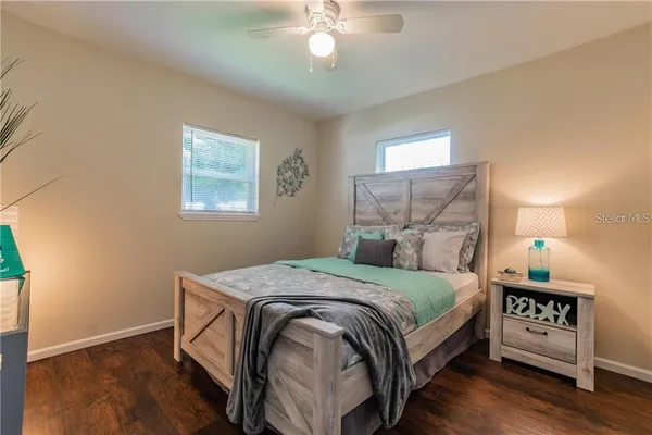 a bedroom with a bed and a chandelier