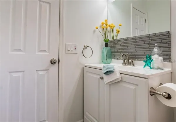 a bathroom with a sink mirror and vanity