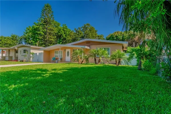 a view of house with yard and green space