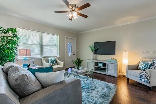 a living room with furniture a fireplace and a flat screen tv