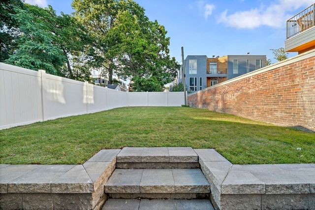 a view of a backyard with sitting area