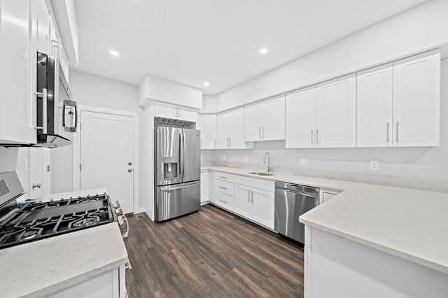 a kitchen with a stove sink and refrigerator