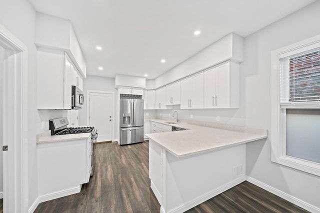 a kitchen with a sink a stove and refrigerator