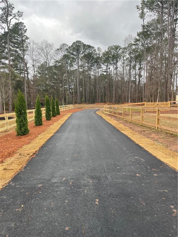1702 Cunningham Road Southwest Marietta, GA 30008 - Photo 4 of 8 a swimming pool with outdoor seating and yard