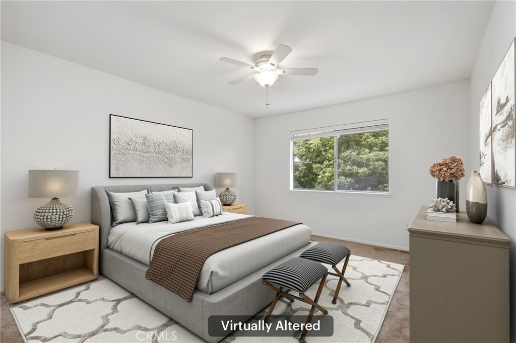 12200 Montecito Road, Unit D301 Seal Beach, CA 90740 - Photo 10 of 28 a bedroom with a bed and a chandelier