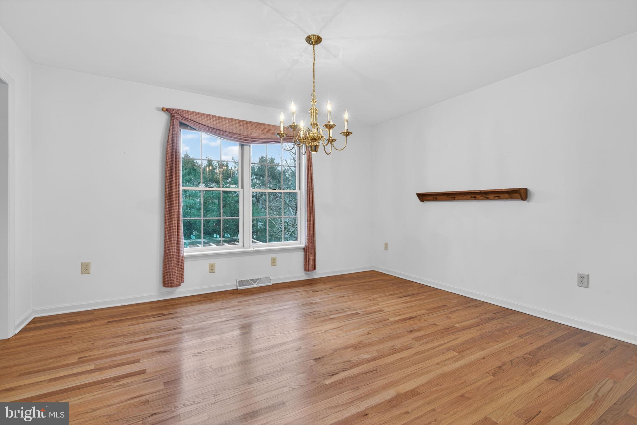 817 Aarons Lane Manheim, PA 17545 - Photo 15 of 64 a view of an empty room with wooden floor and a window