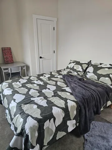 a bed with a bed and a chair