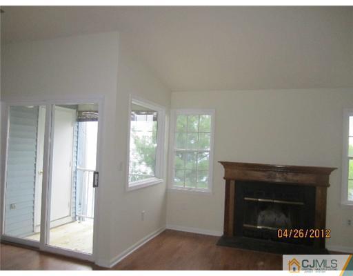 231 Edpas Road New Brunswick, NJ 08901 - Photo 3 of 10 a living room with a fireplace and a floor to ceiling window