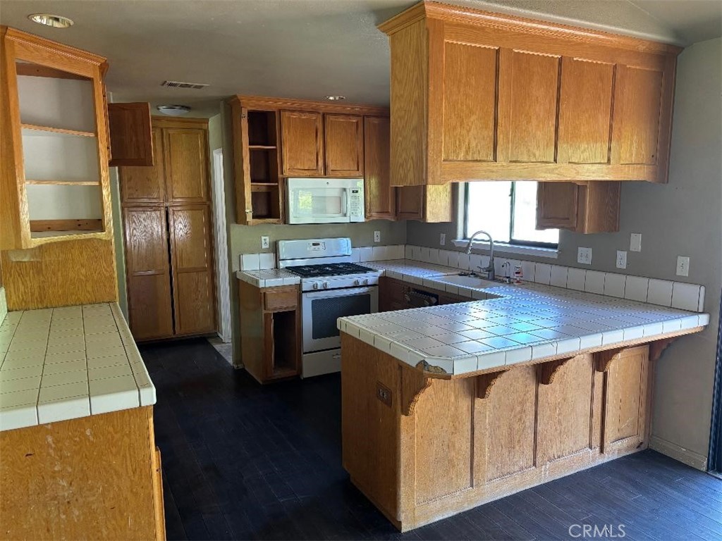 1210 San Ramon Road Atascadero, CA 93422 - Photo 13 of 21 a kitchen with stainless steel appliances granite countertop a sink stove and refrigerator