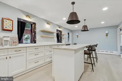 a kitchen with stainless steel appliances a stove a chandelier and a sink