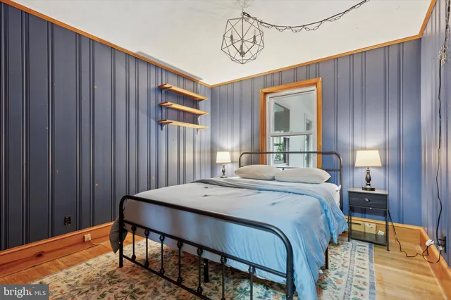 a bedroom with a bed and a mirror