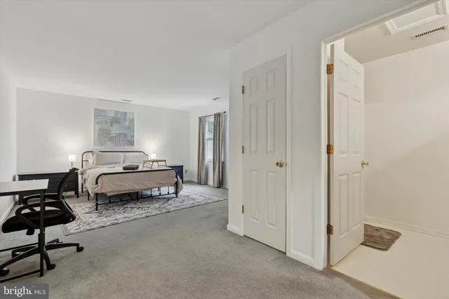 a bedroom with a bed and a chair in it