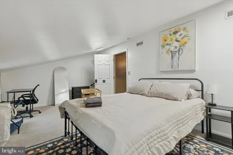 a bedroom with a bed and dresser