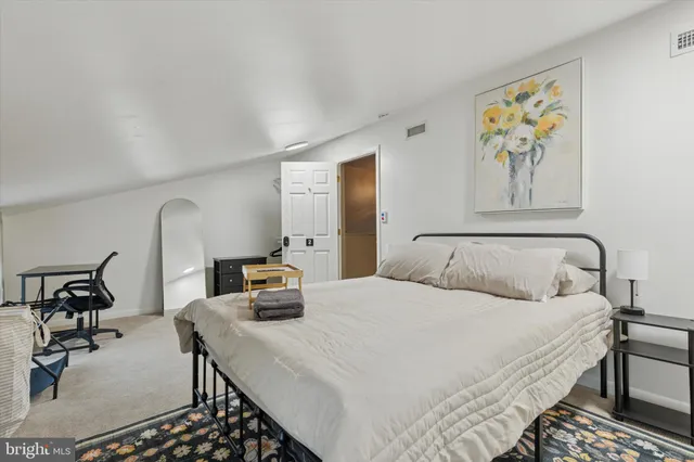 a bedroom with a bed and dresser