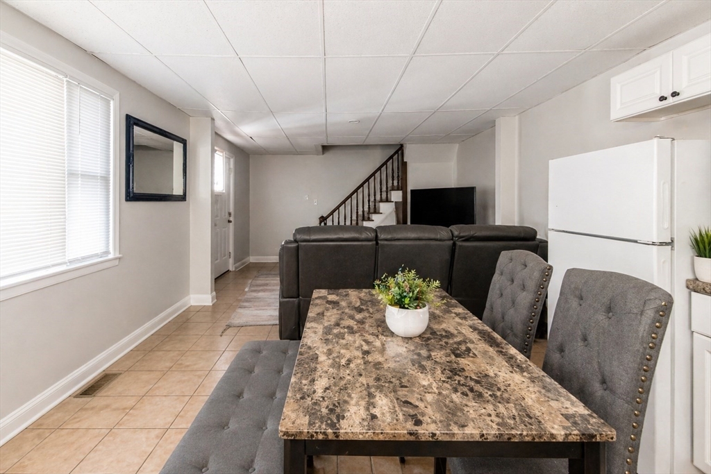 801 North Main Street Fall River, MA 02720 - Photo 14 of 20 a dining room with furniture and a flat screen tv