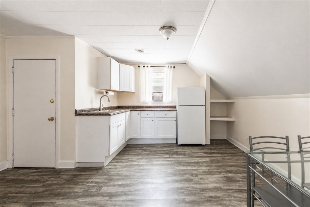 801 North Main Street Fall River, MA 02720 - Photo 16 of 20 a kitchen with granite countertop white cabinets and white appliances