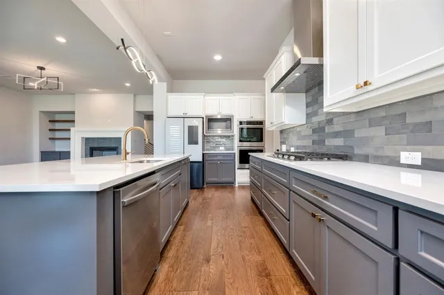 a large kitchen with stainless steel appliances