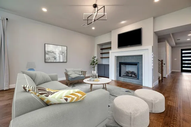 a living room with furniture a fireplace and a flat screen tv