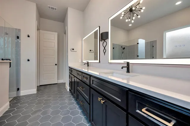 a bathroom with a double vanity sink and a mirror