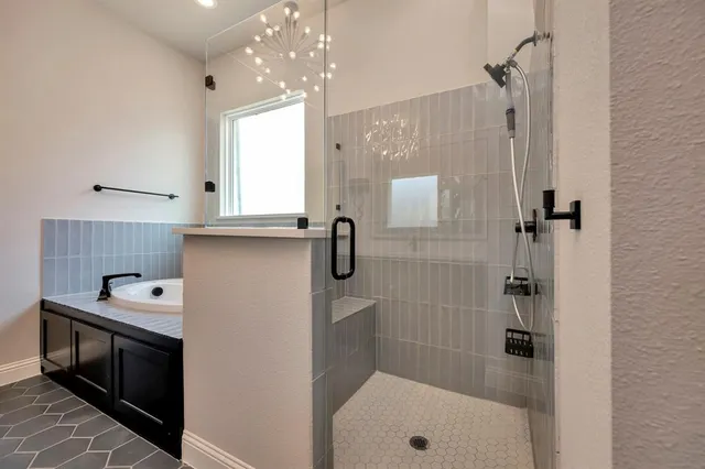 a bathroom with a shower sink and mirror