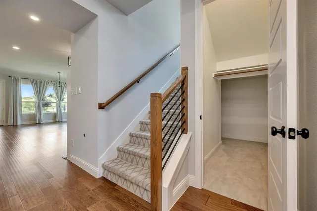 a view of entryway and hall with wooden floor
