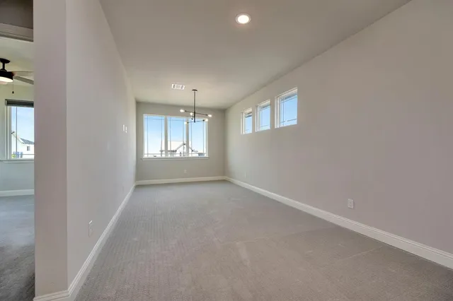 an empty room with windows and closet in a room