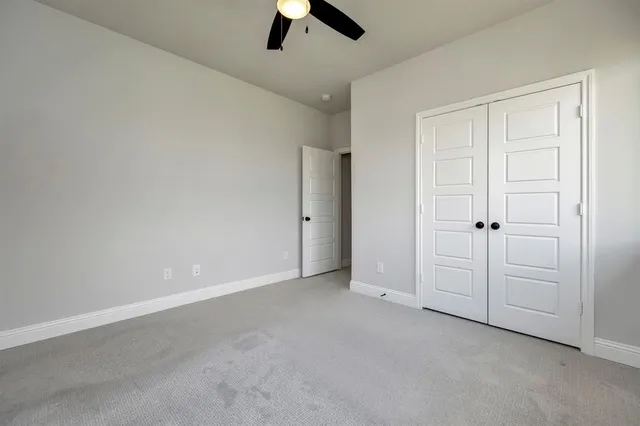 an empty room with ceiling fan