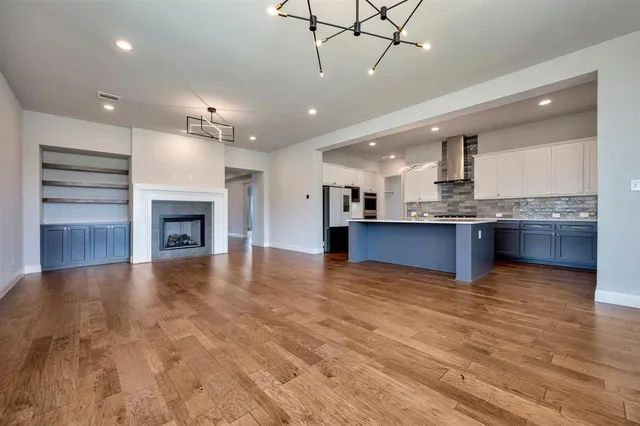 a view of a kitchen with a sink and a fireplace