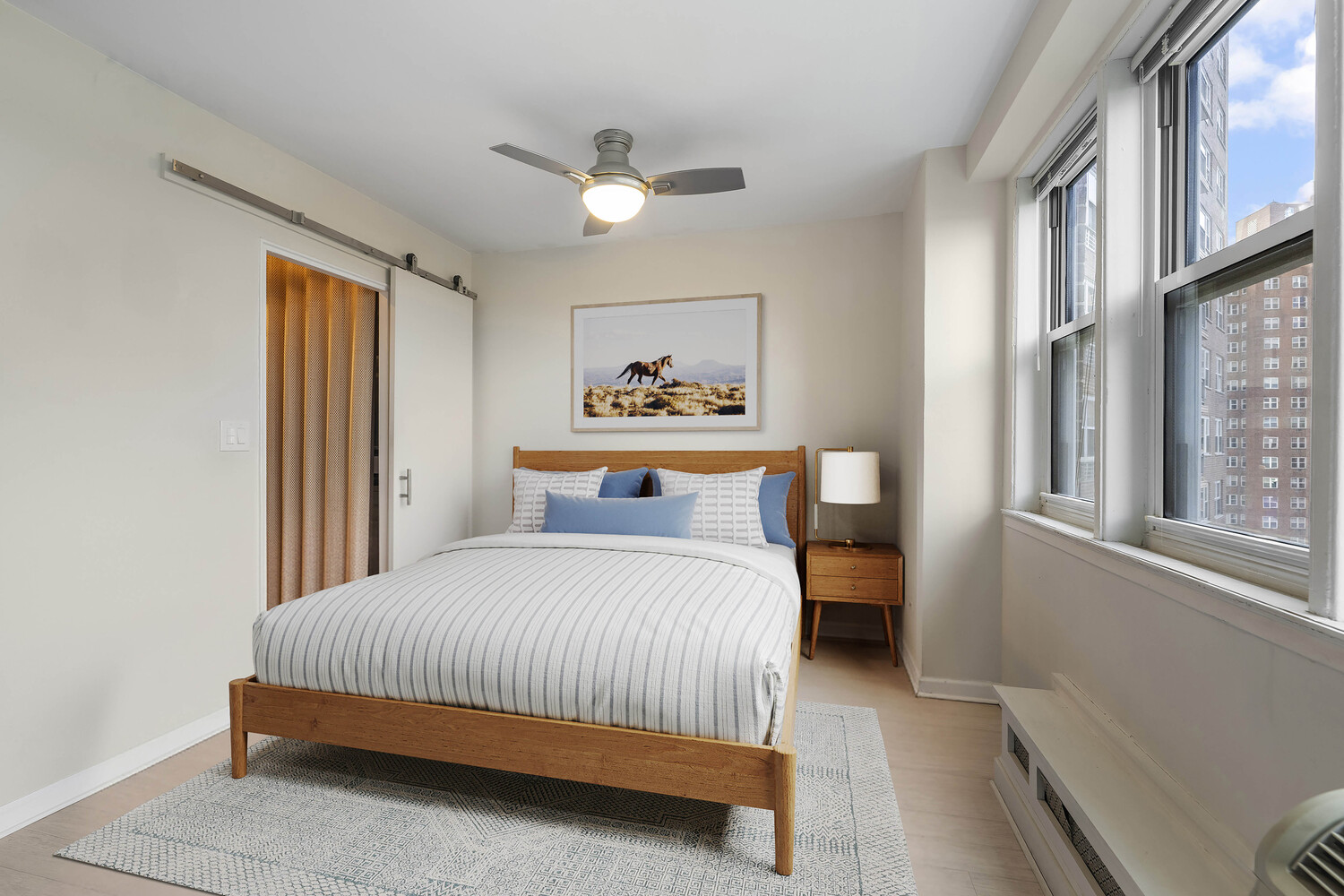 a bedroom with a bed and a painting on the wall