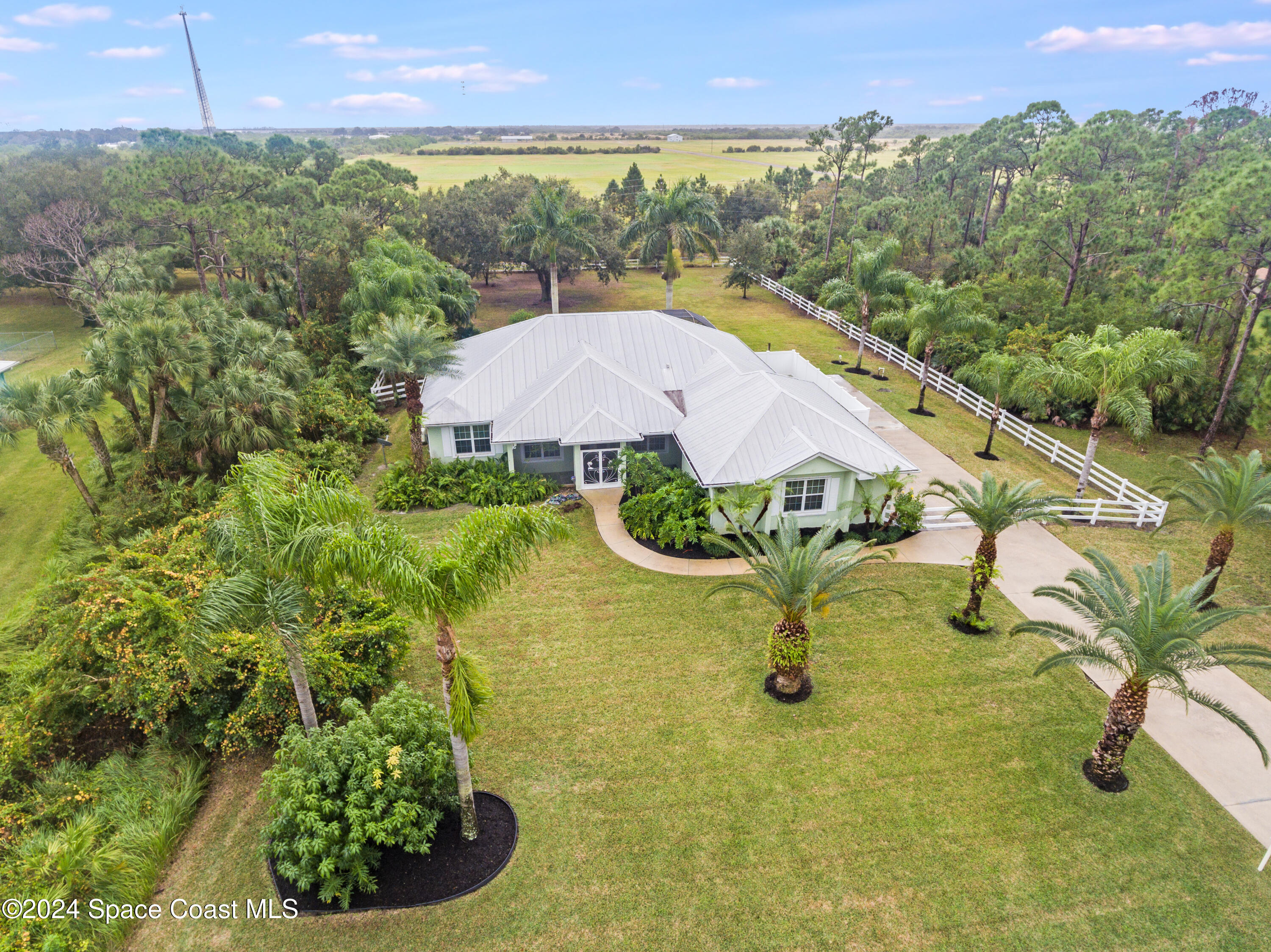a view of a swimming pool with a yard and plants