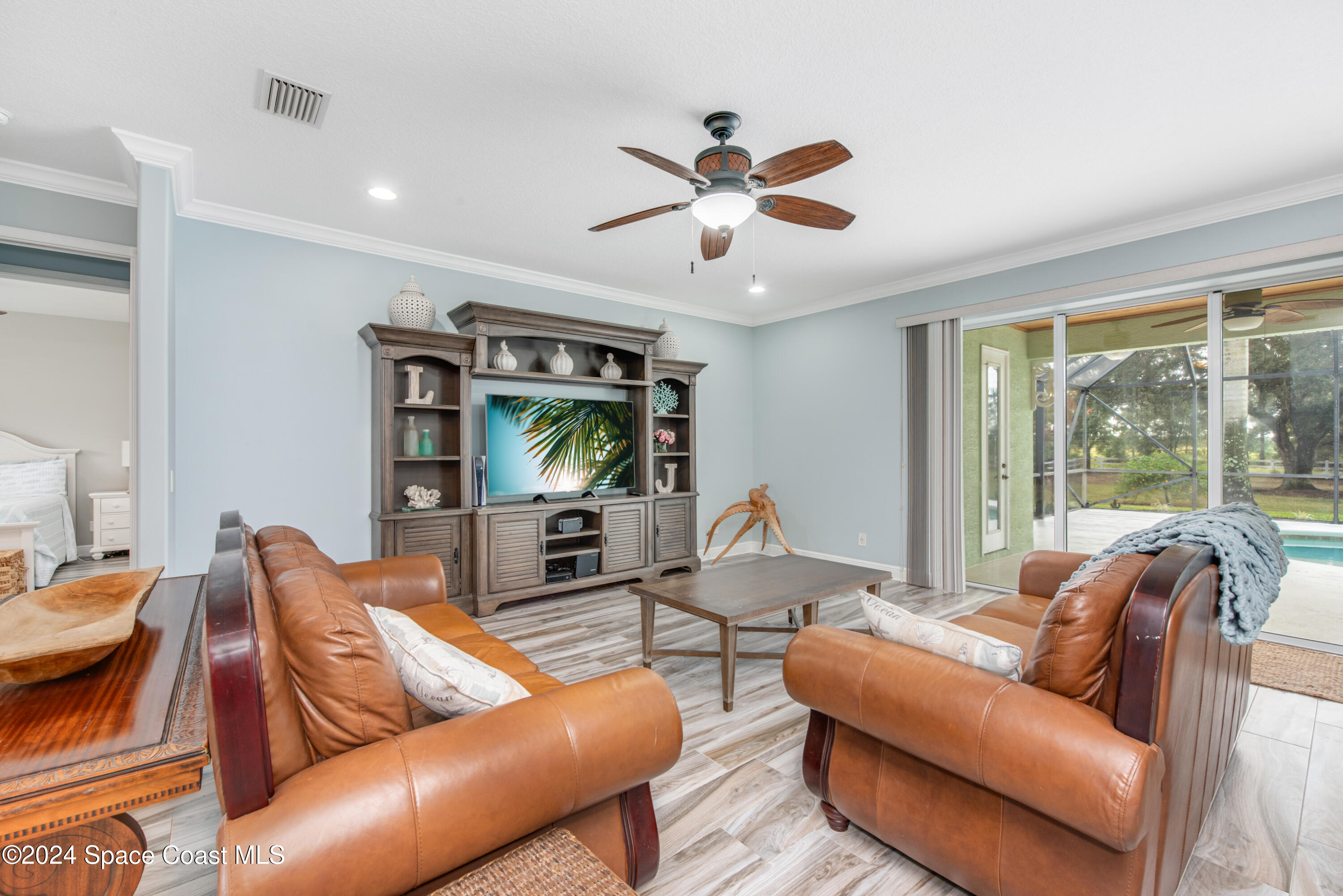 4153 Red Bay Street Grant, FL 32949 - Photo 18 of 63 a living room with furniture ceiling fan and a large window