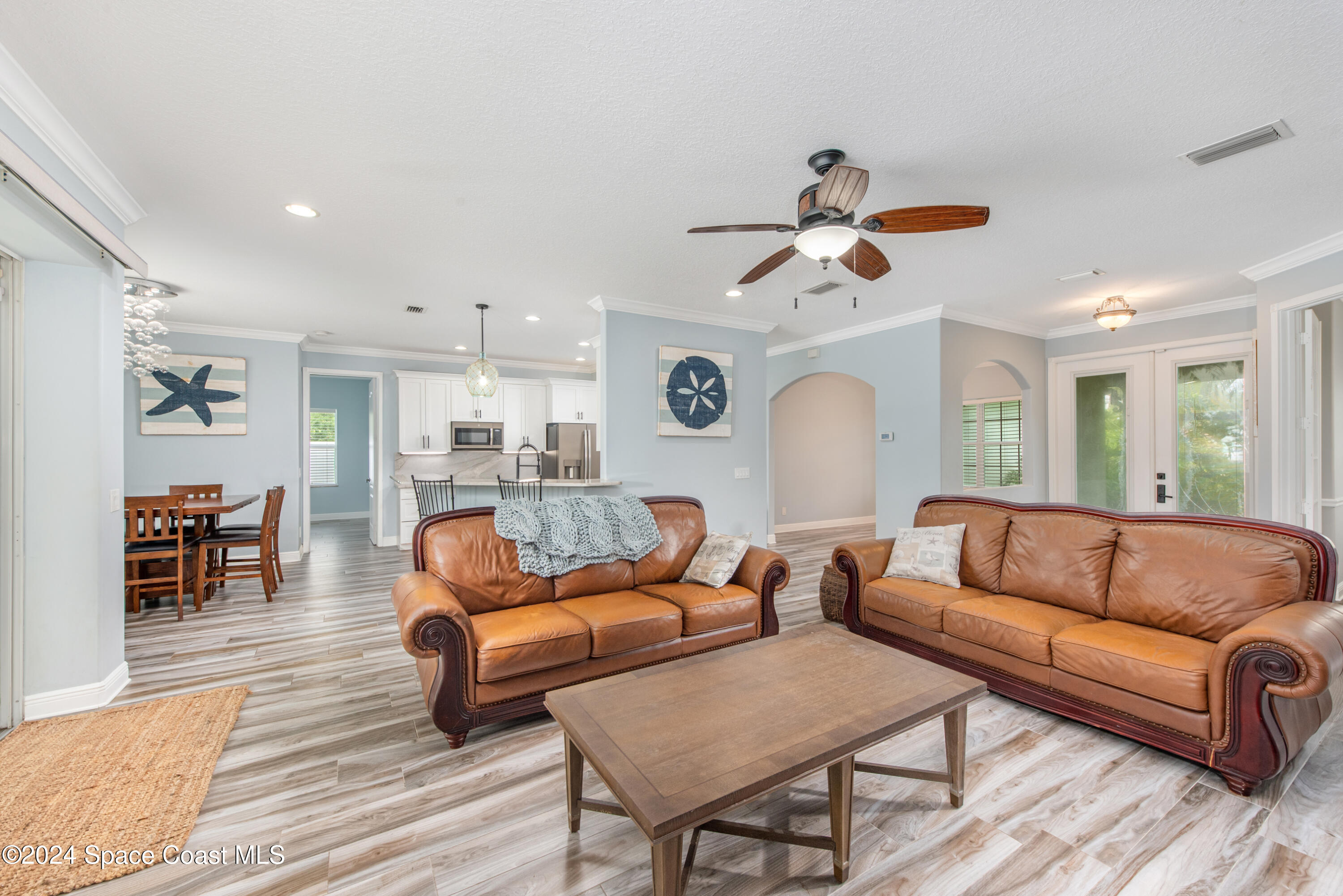 4153 Red Bay Street Grant, FL 32949 - Photo 19 of 63 a living room with furniture and a chandelier