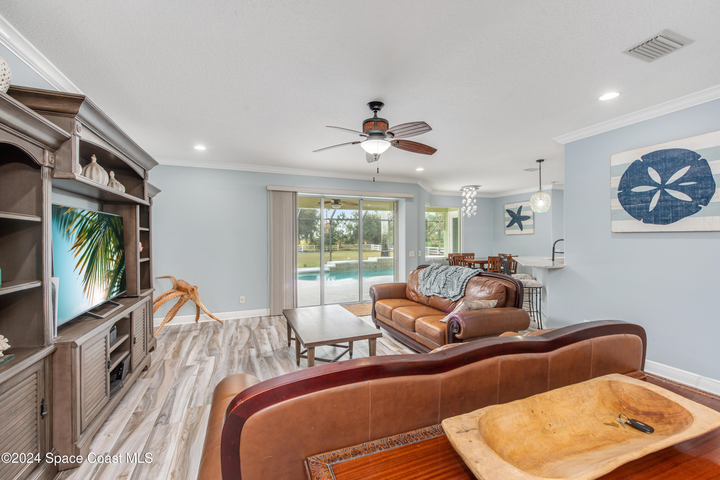 4153 Red Bay Street Grant, FL 32949 - Photo 21 of 63 a living room with furniture a flat screen tv and a large window