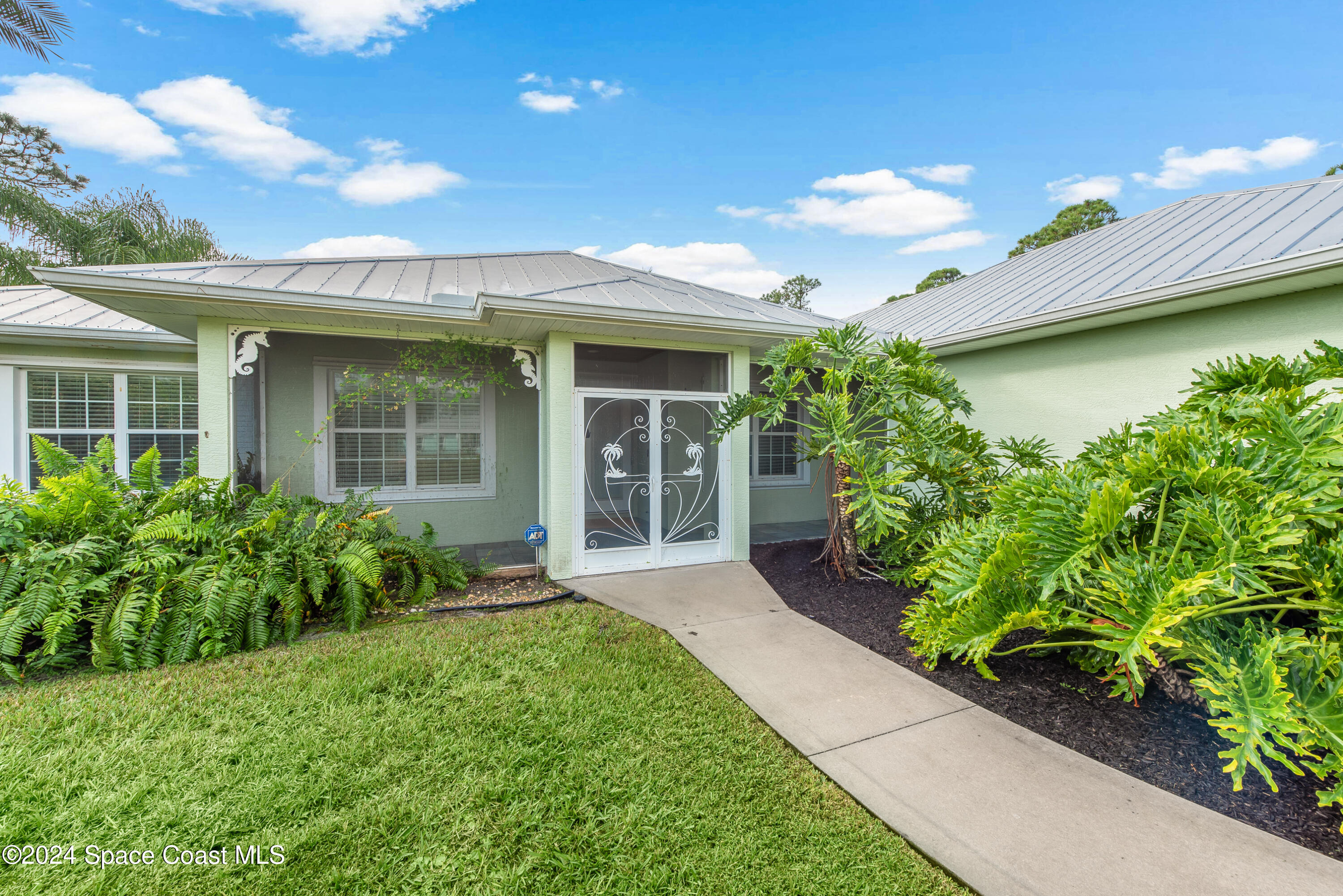 4153 Red Bay Street Grant, FL 32949 - Photo 3 of 63 a front view of a house with garden