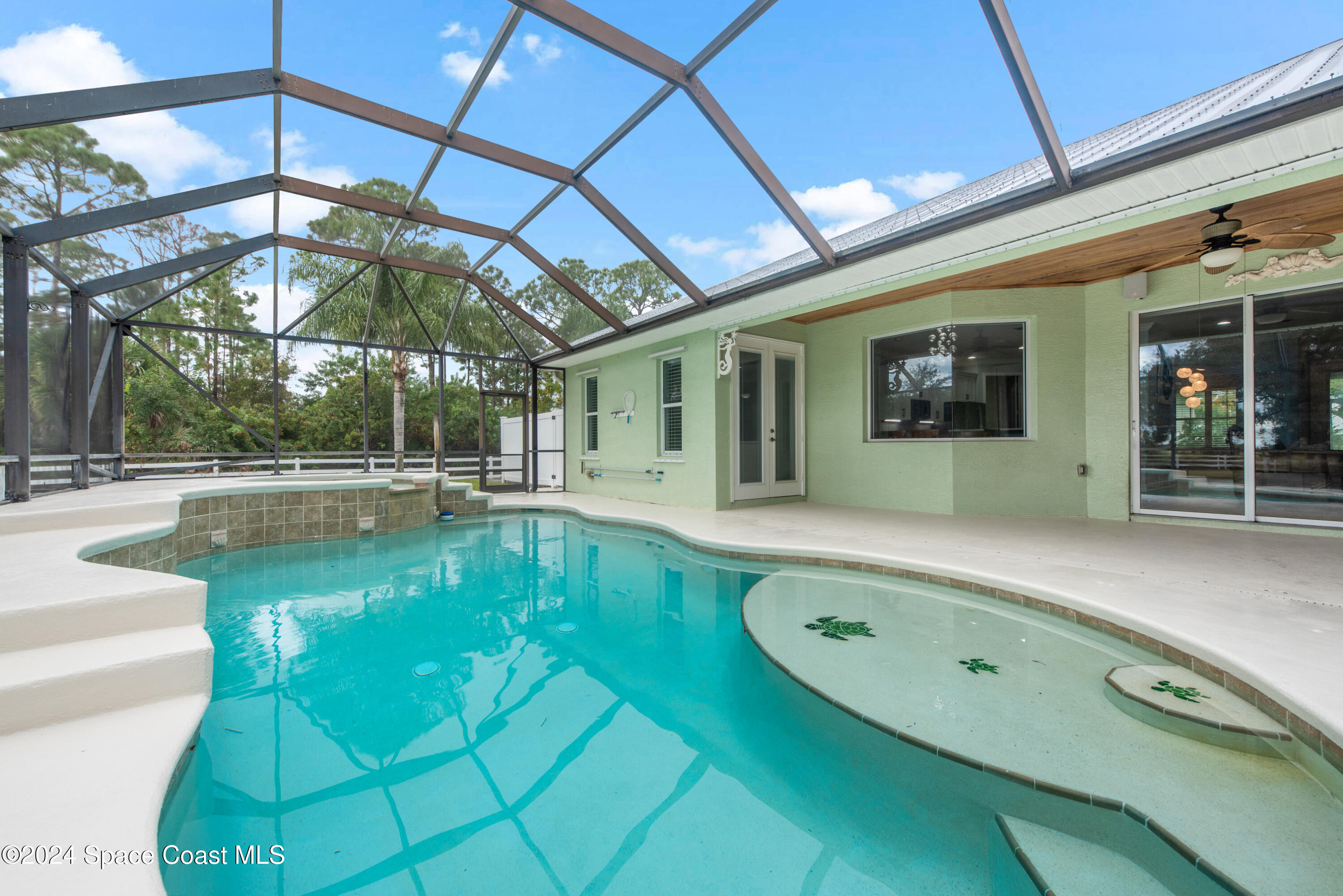 4153 Red Bay Street Grant, FL 32949 - Photo 32 of 63 a view of a swimming pool with a patio