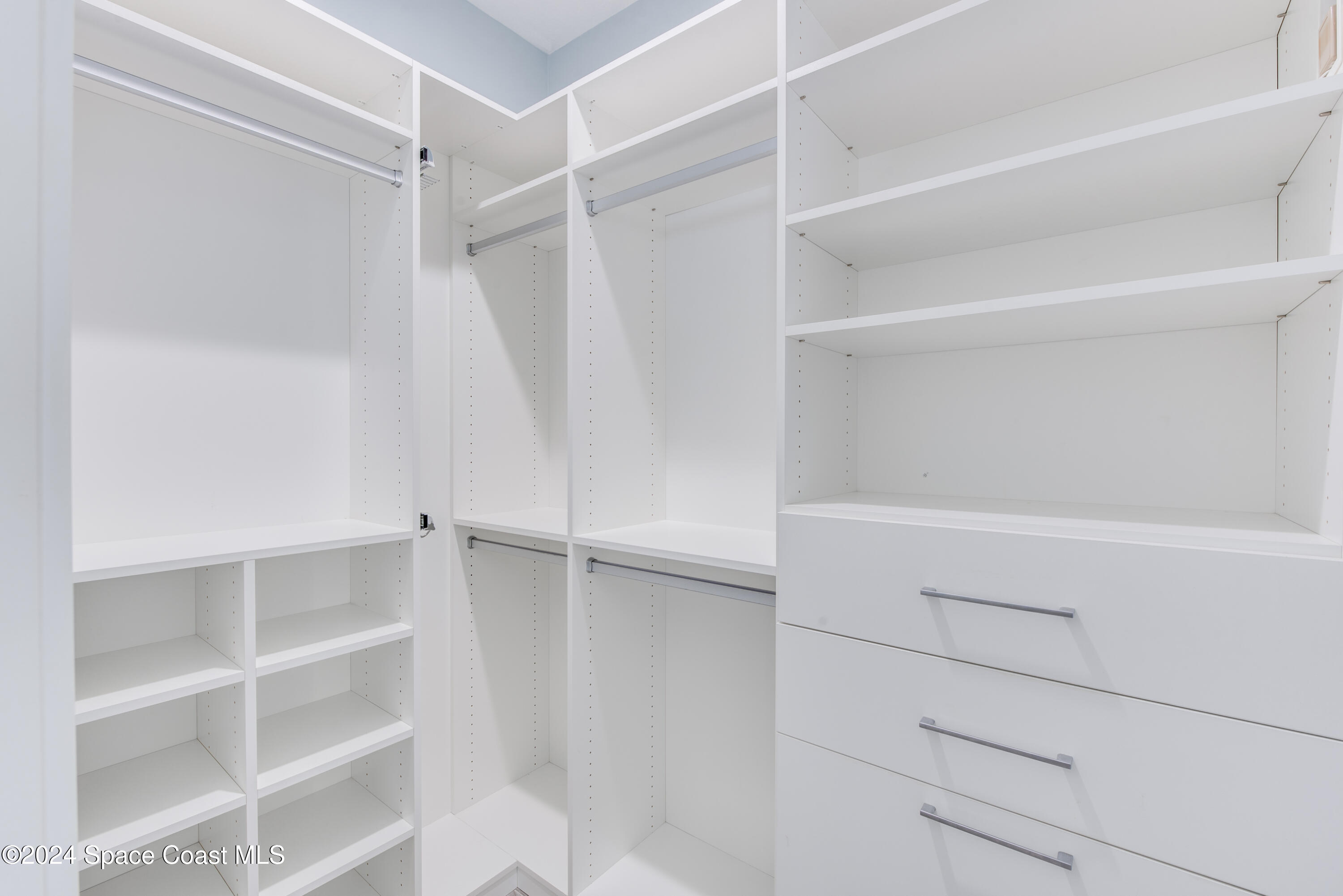 4153 Red Bay Street Grant, FL 32949 - Photo 38 of 63 a view of walk in closet with empty racks