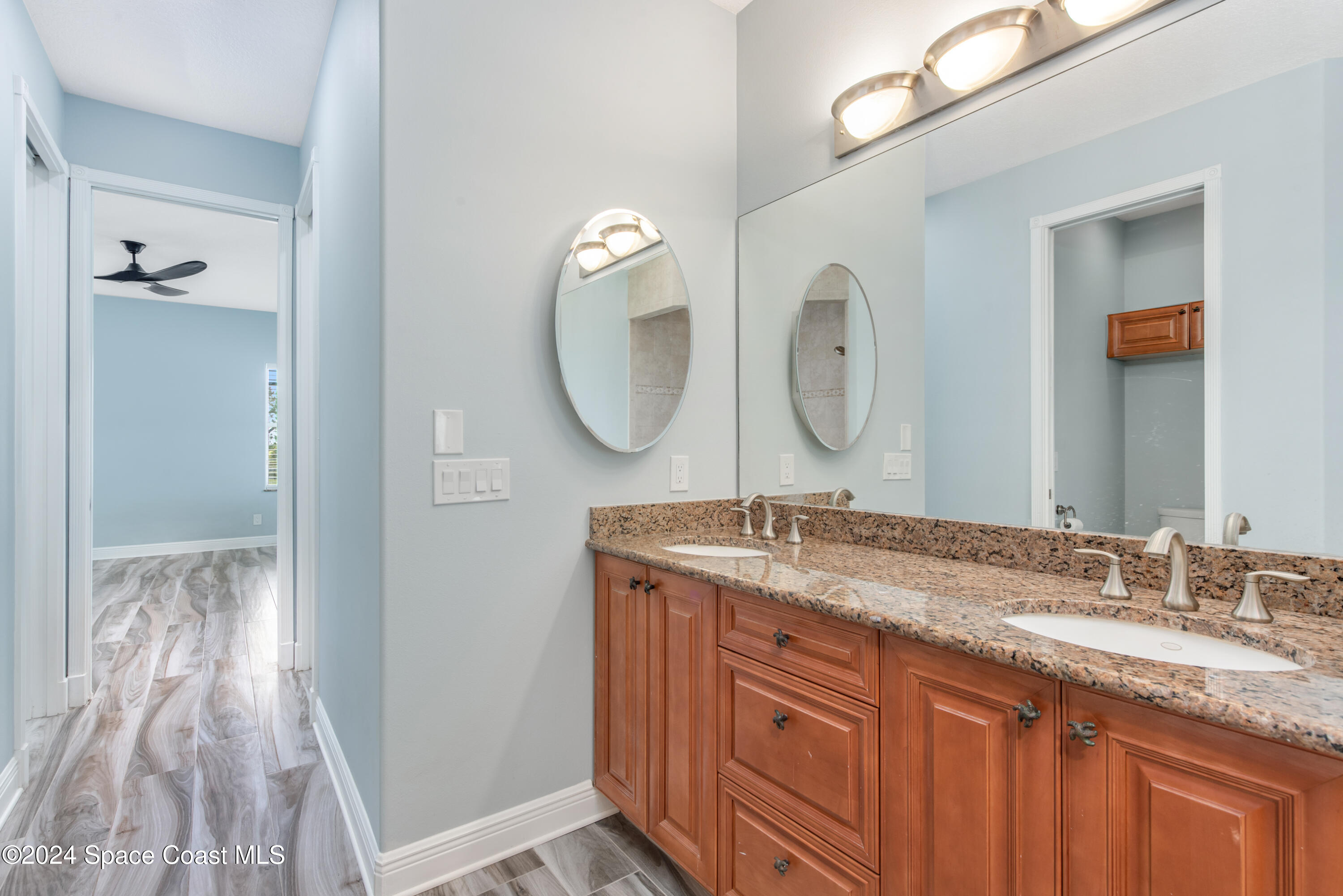 4153 Red Bay Street Grant, FL 32949 - Photo 41 of 63 a bathroom with a granite countertop sink vanity and mirror