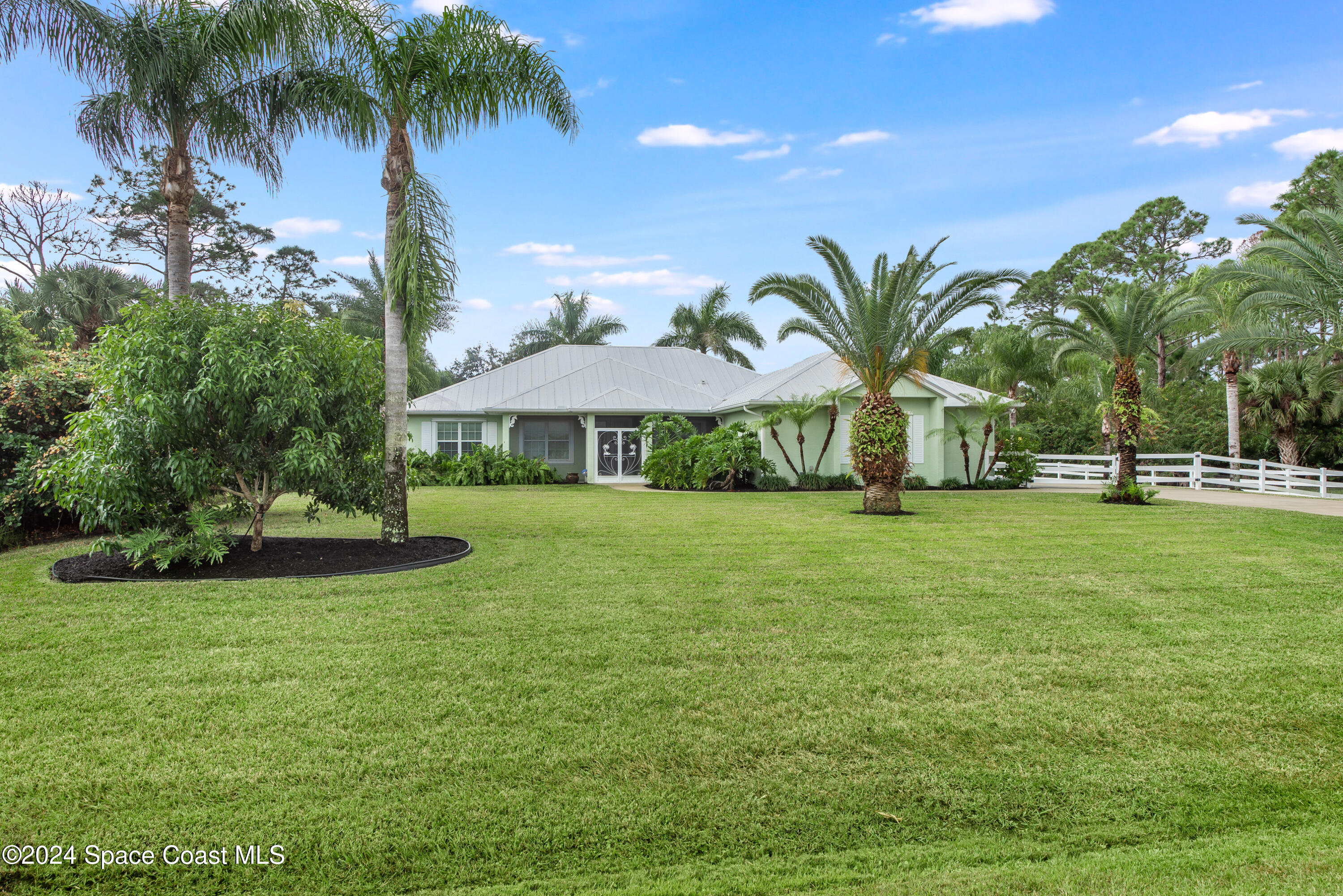 4153 Red Bay Street Grant, FL 32949 - Photo 44 of 63 a view of a swimming pool with a garden and plants