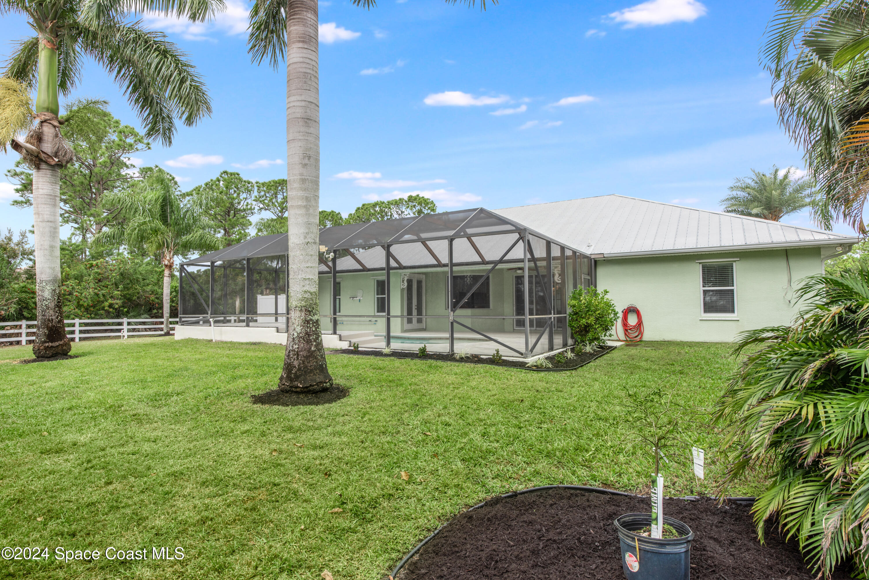 4153 Red Bay Street Grant, FL 32949 - Photo 47 of 63 a front view of a house with garden
