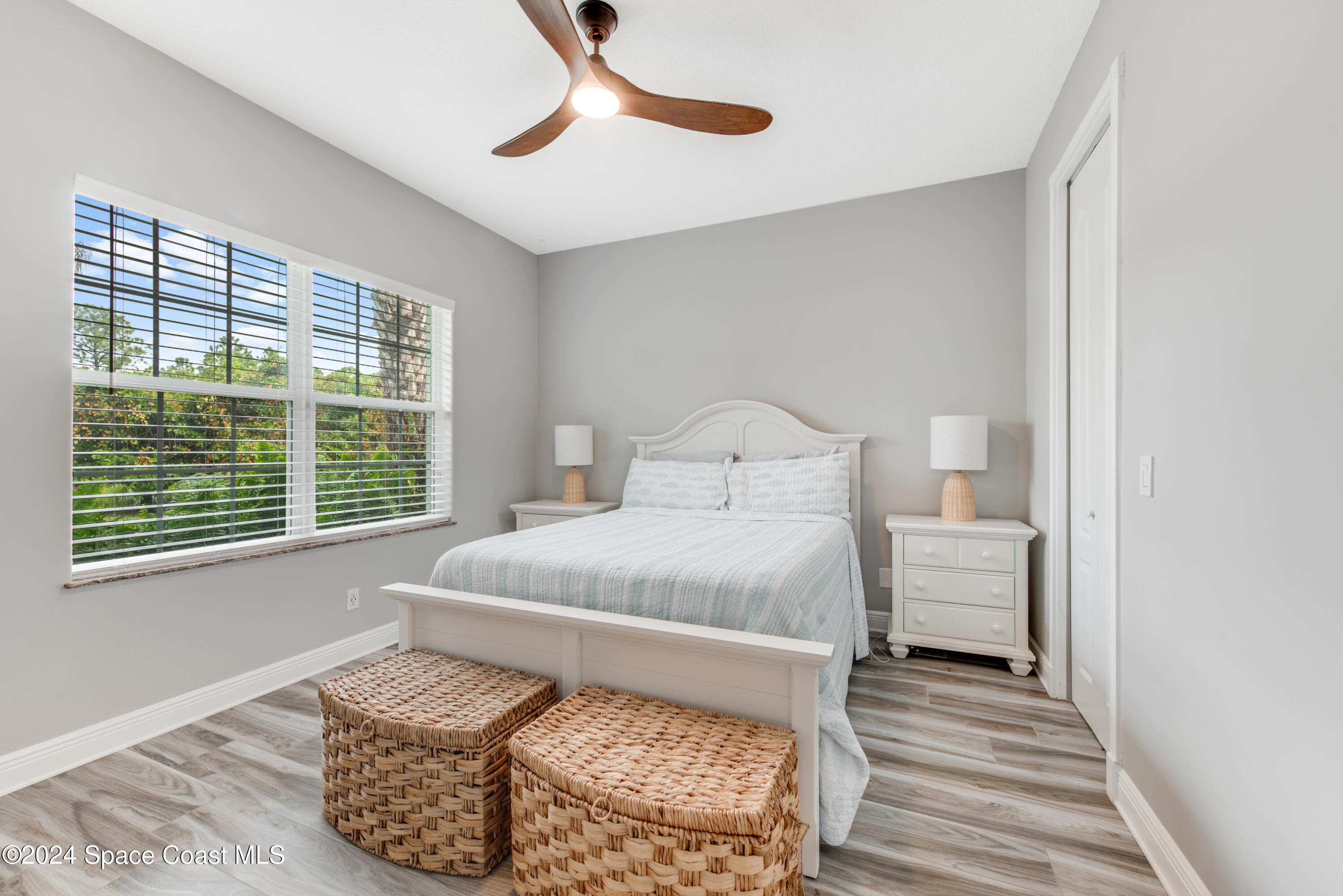 4153 Red Bay Street Grant, FL 32949 - Photo 48 of 63 a bedroom with a bed and wooden floor