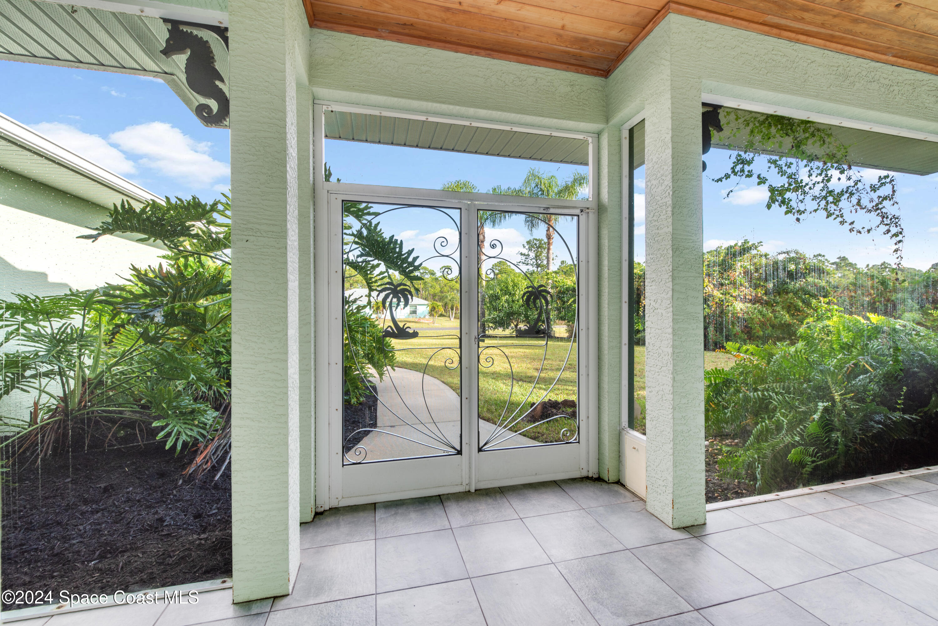 4153 Red Bay Street Grant, FL 32949 - Photo 7 of 63 a view of a glass door with a balcony