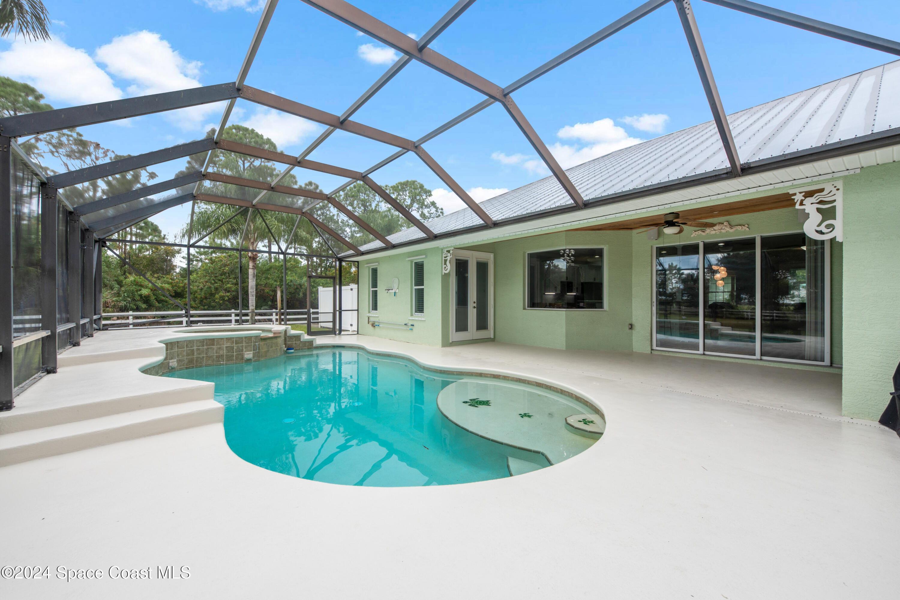 4153 Red Bay Street Grant, FL 32949 - Photo 9 of 63 a view of a swimming pool with a patio