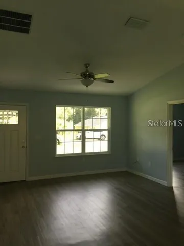 a view of a kitchen with a sink and a refrigerator