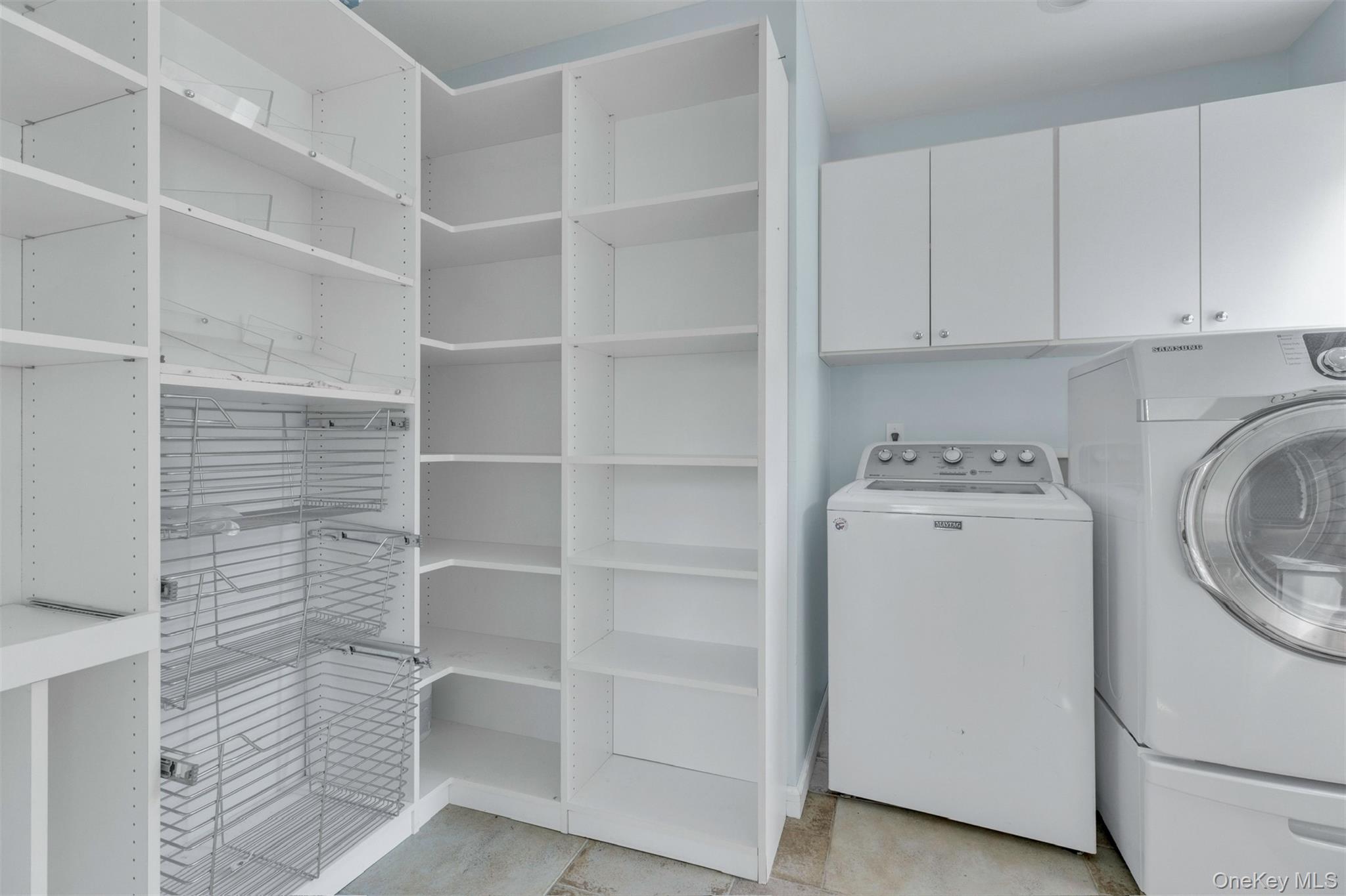 345 Colonial Road Southold, NY 11971 - Photo 18 of 43 a utility room with cabinets washer and dryer