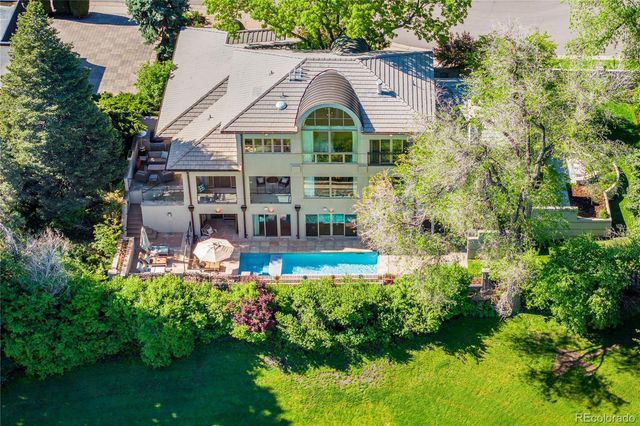 a aerial view of a house with a big yard and large trees